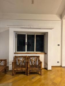 a room with two benches in front of a window at Meridian penthouse in Kolhapur