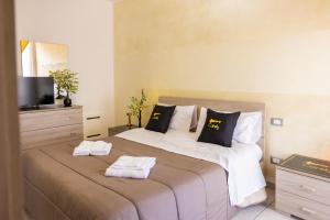 a bedroom with a large bed with towels on it at Cairoly Residence in Termoli