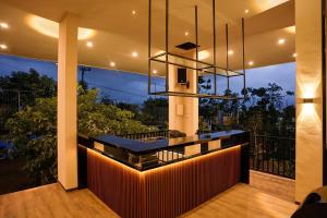 a kitchen with a bar in a house with a balcony at Zalfa Hills in Pandansari-kidul