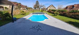 a swimming pool in the middle of a driveway at Gite Le Tamaris in Mantry