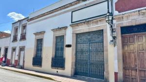a building with two garage doors on a street at Casona Bartolome in Morelia