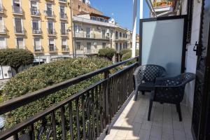 a balcony with a chair and a sign on a building at Cairoly Residence in Termoli