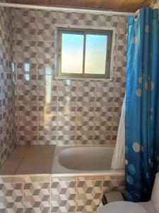 un bagno con vasca e finestra di Cabañas Vitalis a Curanipe Altre 5 foto