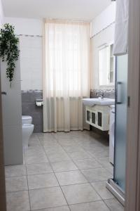 a bathroom with a toilet and a sink at Cairoly Residence in Termoli +28 photos