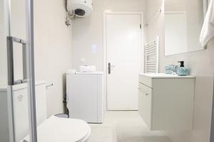 a white bathroom with a toilet and a sink at Smart Home Corfu 4 in Alykes Potamou +25 photos