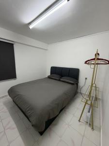 a bedroom with a bed in a white room at Kuala Terla Cameron Cozy Home - Self Check-in in Kampung Kuala Terla