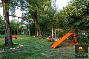 een speeltuin met een oranje glijbaan in een park bij Casa El Chaparral Villa Dolores, Traslasierra 3 in Piedra Pintada