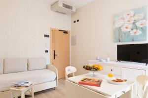 a living room with a couch and a table at Mondial Beauty Suite in Bellaria-Igea Marina