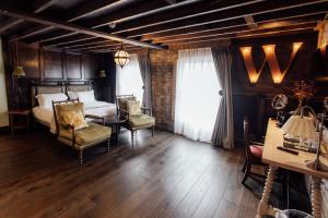 a bedroom with a bed and a table and chairs at The Wildings Northumberland in Morpeth