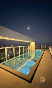 a swimming pool on top of a building at night at Apto Home & Club em Capão da Canoa in Capão da Canoa