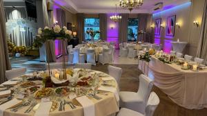 a banquet hall with white tables and white chairs at Pensjonat Cezar in Siemiatycze