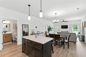 a kitchen and living room with a table and a dining room at Heart of Cedartown | 0.3 miles from the Silver Comet Trail in Cedartown