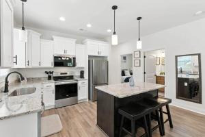 a kitchen with white cabinets and a counter top at Heart of Cedartown | 0.3 miles from the Silver Comet Trail in Cedartown
