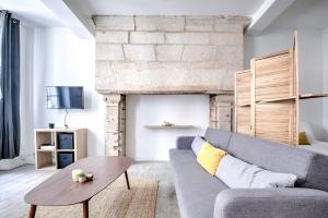 a living room with a couch and a table at La sagesse in Périgueux