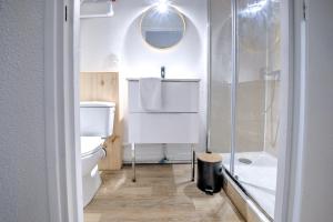 a bathroom with a shower and a toilet and a sink at La sagesse in Périgueux