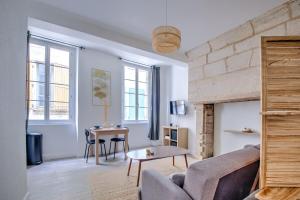 een woonkamer met een bank en een tafel bij Wisdom at heart in Périgueux