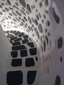 a room with a ceiling with rocks on it at Casa Milos Windmill Alonissos in Alonnisos +19 photos