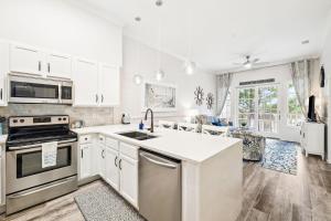 a kitchen with white cabinets and a counter top at The Magnolia by 30A Escapes in Rosemary Beach