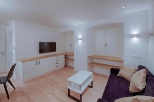 een woonkamer met een bank en een tafel bij ADAM Suites - Brixen Card included in Bressanone