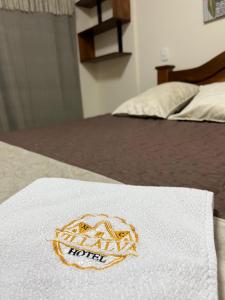 a white towel sitting on top of a bed at Hotel Villalva, Cucunuba Cundinamarca in Cucunubá +2 photos