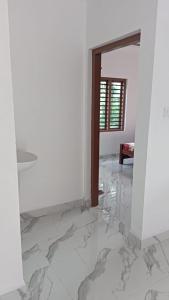 a room with white walls and a marble floor at EVA Residency in Kallar