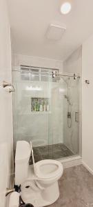 une salle de bains avec toilettes et douche en verre dans l'établissement Welcoming & Spacious 2-Bedroom Guest Suite in Torrance 20 Minutes from LAX, à Torrance