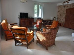 a living room with chairs and a table and a dining room at Trivalou in Fauch