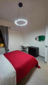 a bedroom with a large bed with a red blanket at Agli Archi Eco House in Chieti