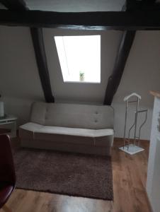 a living room with a couch and a window at Gästeoase einfach wohl fühlen in Wolfhagen