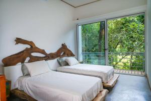 En eller flere senge i et værelse på Casa Bromelia + 18 billeder