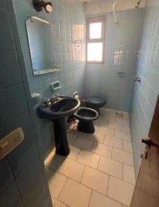 a bathroom with a sink and a toilet at Miramar 19 in Miramar