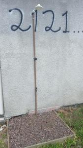 a street light in front of a white building at Residencial Daitx in Capão da Canoa