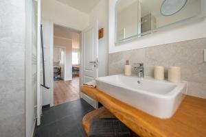 a bathroom with a white sink and a mirror at Haus Lindolino in Elsterheide +196 photos
