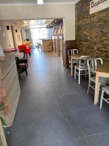 a restaurant with tables and chairs and a brick wall at Hotel Stella in Talca