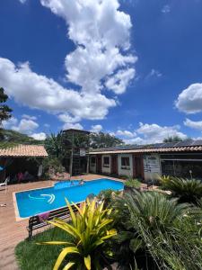 a swimming pool in front of a house at Pousada em Itupeva in Itupeva