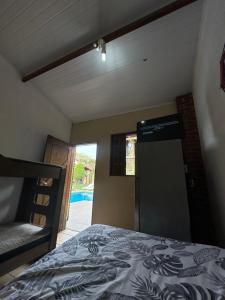a bedroom with a bed and a view of a pool at Pousada em Itupeva in Itupeva