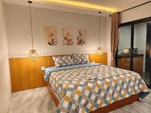 a bedroom with a bed with two lights on it at Ingtara at Lanta in Ko Lanta