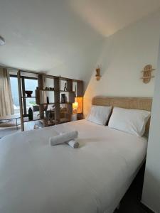 a bedroom with a large white bed with a view at Les pieds dans l'eau in Thonon-les-Bains