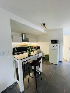 a kitchen with a white island in a room at Les pieds dans l'eau in Thonon-les-Bains
