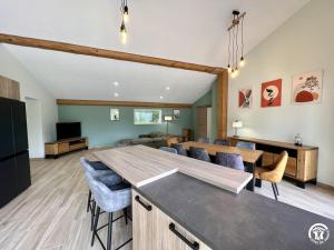 a kitchen and living room with a table and chairs at Gite du tatou in Roquefeuil +11 photos