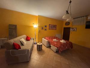 a living room with a couch and a bed at Taverna relais in Marco Simone