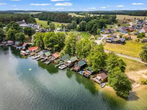 an aerial view of a village on a river at Haus am Seeufer mit Badestelle in 200m, große Sonnenterrasse, umzäunter Garten, Hunde willkommen in Rheinsberg