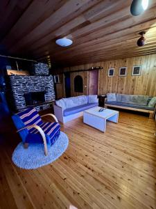 a living room with a couch and a fireplace at Villa Lakeside in Utsjoki