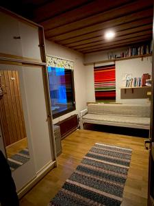 a living room with a couch and a large window at Villa Lakeside in Utsjoki