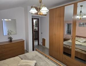 a bedroom with a bed and a dresser and a mirror at Mely House centralissimo in Castel di Sangro