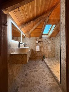 a bathroom with a sink and a wooden ceiling at Chalet Oslo by Lodji in Saint-Marcel