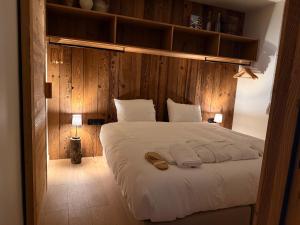 a bedroom with a bed with two towels on it at Chalet Oslo by Lodji in Saint-Marcel