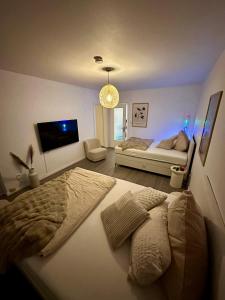 a bedroom with a large bed and a couch at Little Royal in Garbsen
