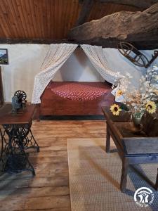 a room with a bed and a table with flowers at Calouze in Gijounet +40 photos