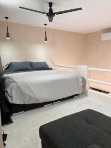a bedroom with a bed and a ceiling fan at La Belle Dojo in Chelem +26 photos